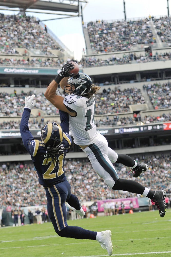 Philadelphia Eagles' Riley Cooper (14) pulls in a touchdown pass against St. Louis Rams' Janoris Jenkins (21) on Sunday.