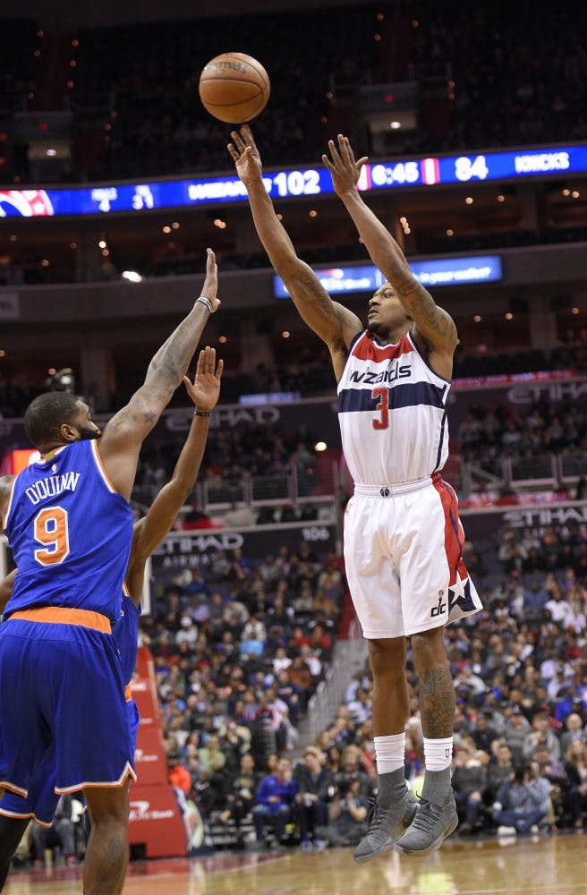 Washington Wizards guard Bradley Beal (3) shoots against New York Knicks center Kyle O'Quinn (9) during the second half of an NBA basketball game, Tuesday, Jan. 31, 2017, in Washington. The Wizards won 117-101. (AP Photo/Nick Wass)