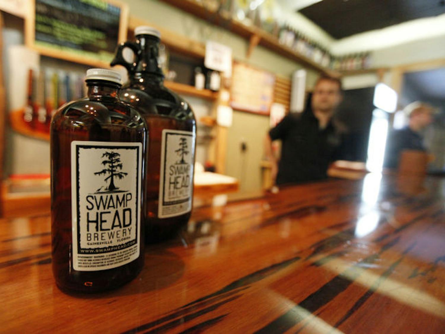 Both 32-ounce jugs and one-gallon jugs of beer, sold at Swamp Head Brewery, are legal container sizes in Florida. Lobbyists are trying to legalize the 64-ounce size beverages.