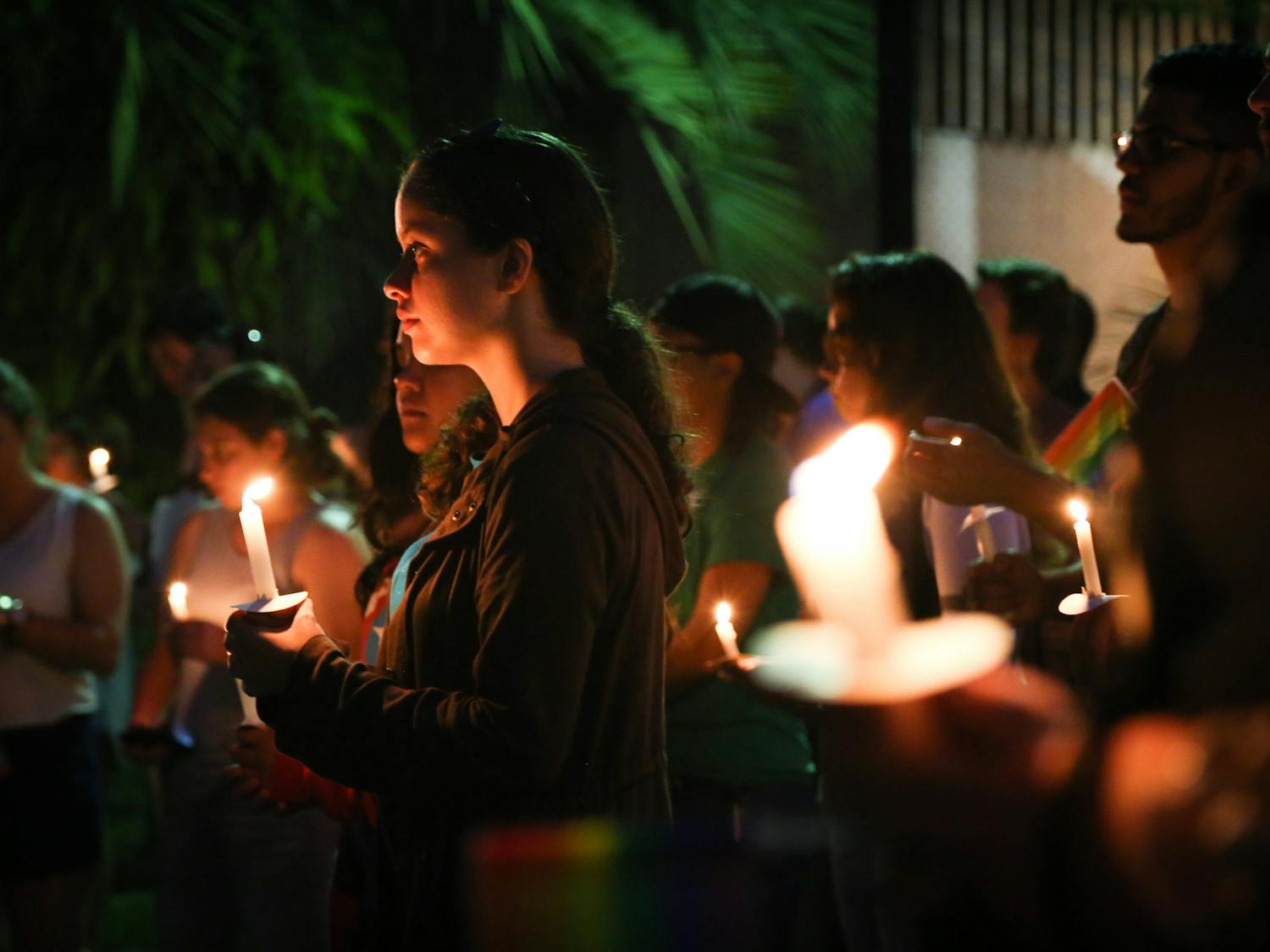 Frances Patala, a 20-year-old UF animal sciences senior, listens to the speeches made on Tuesday evening at the Pulse Commemoration and Unity Ceremony. About 650 people came to the event, which included seven speakers and a candlelight vigil.