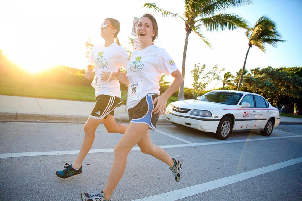 Sarah Lambert, 21, jogging with friend, Ryenne Dietrick, 17 at Race for Hope –&nbsp;Aid to Victims of Domestic Abuse in Delray Beach.