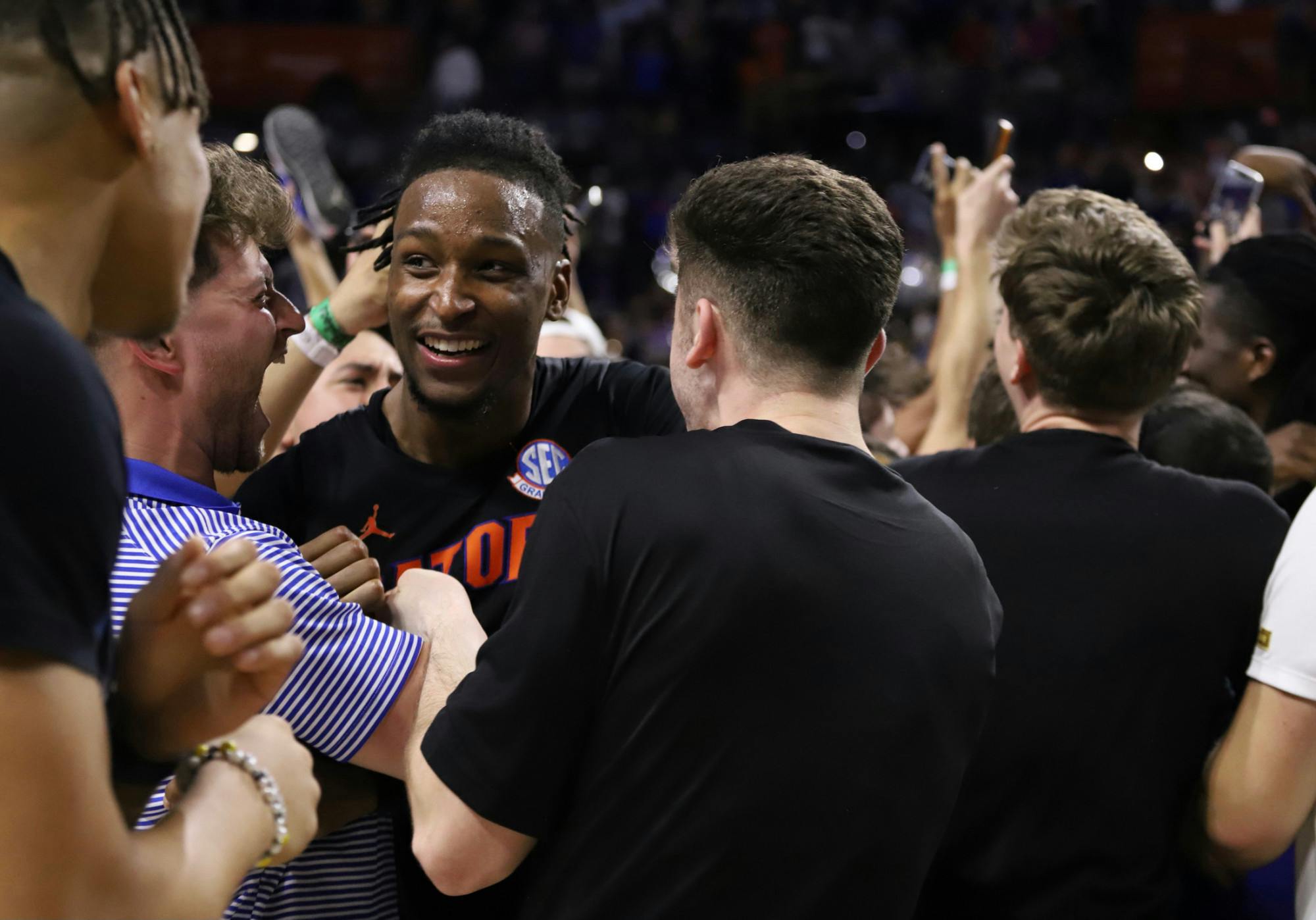 Florida guard Phlandrous Fleming Jr celebrates victory over No. 2 Auburn after Gator fans storm the court.