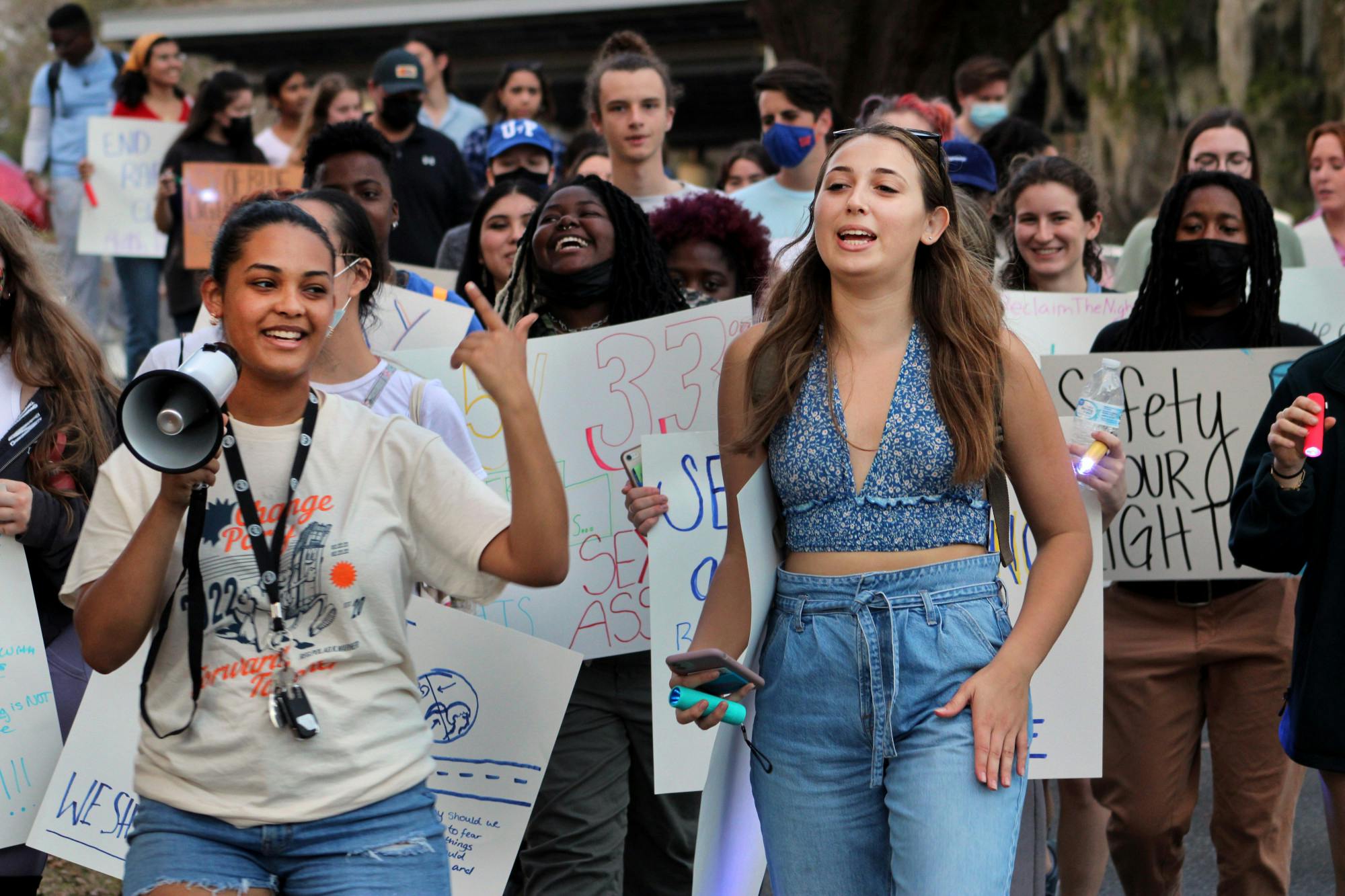 Gabrielle Adekunle (left), Change Party's presidential nominee, and Alexandra Quintana lead protestors down Fraternity Row on Friday, Feb. 4. The rally was held by Change Party to advocate for more emergency blue lights along Fraternity Row.