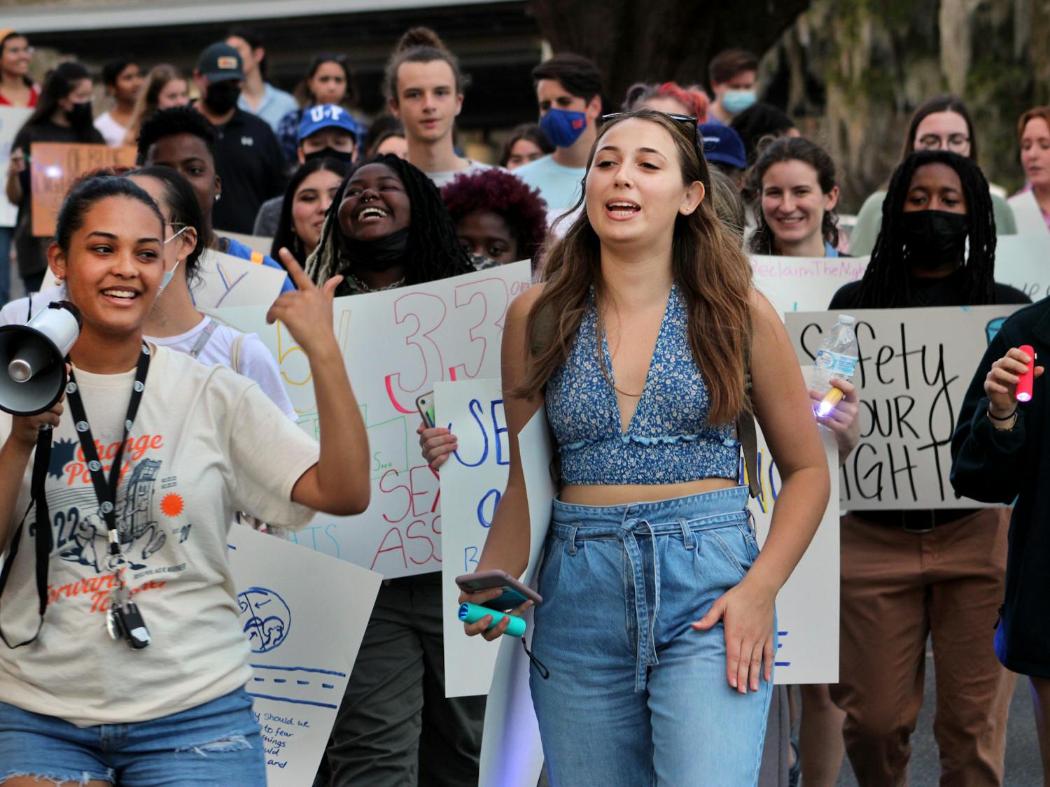 Gabrielle Adekunle (left), Change Party's presidential nominee, and Alexandra Quintana lead protestors down Fraternity Row on Friday, Feb. 4. The rally was held by Change Party to advocate for more emergency blue lights along Fraternity Row.