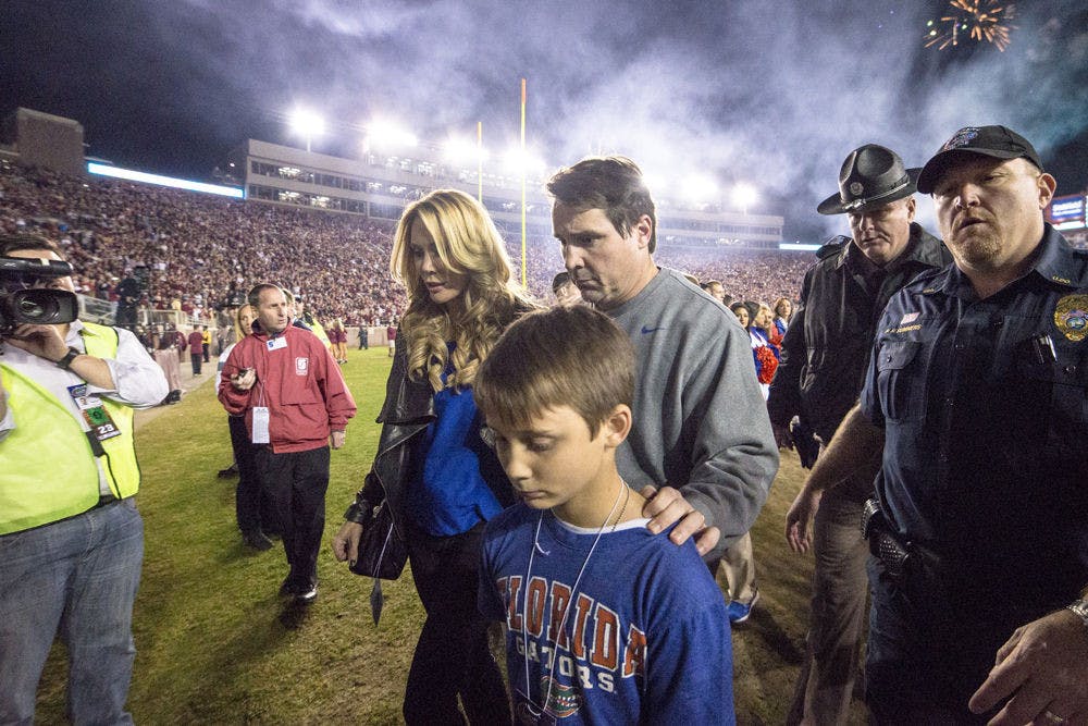 <p>UF coach Will Muschamp walks off the field at Doak Campbell Stadium with his wife and kids following Florida's 24-19 loss to No. 3 Florida State on Saturday in Tallahassee.</p>