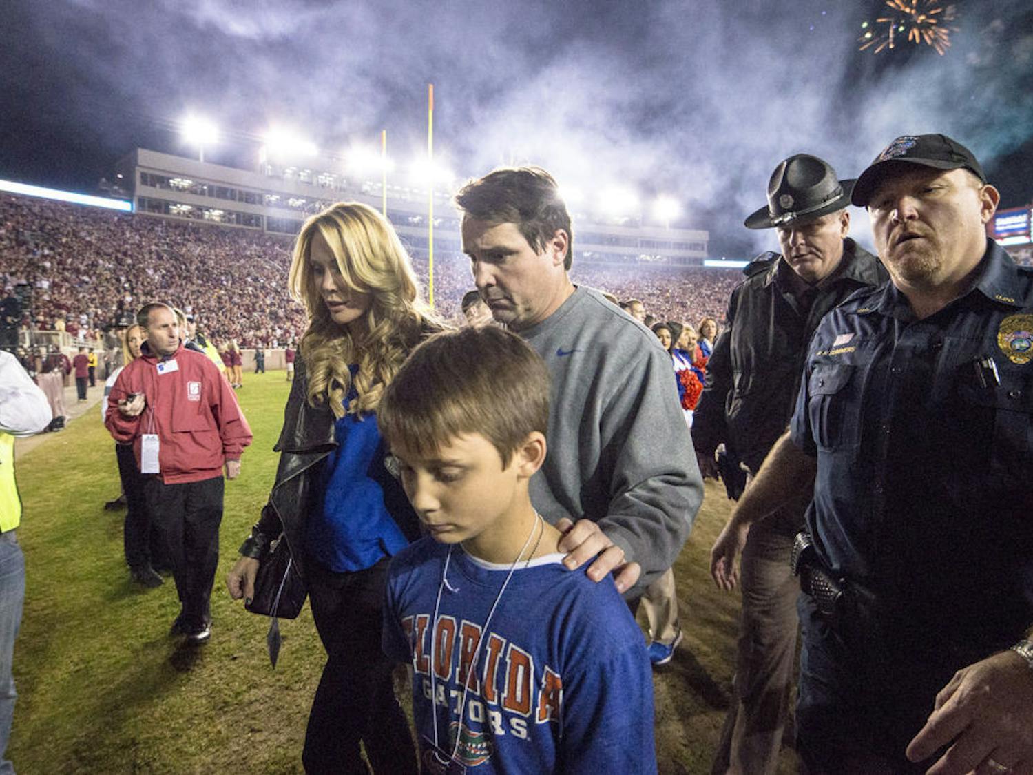 UF coach Will Muschamp walks off the field at Doak Campbell Stadium with his wife and kids following Florida's 24-19 loss to No. 3 Florida State on Saturday in Tallahassee.