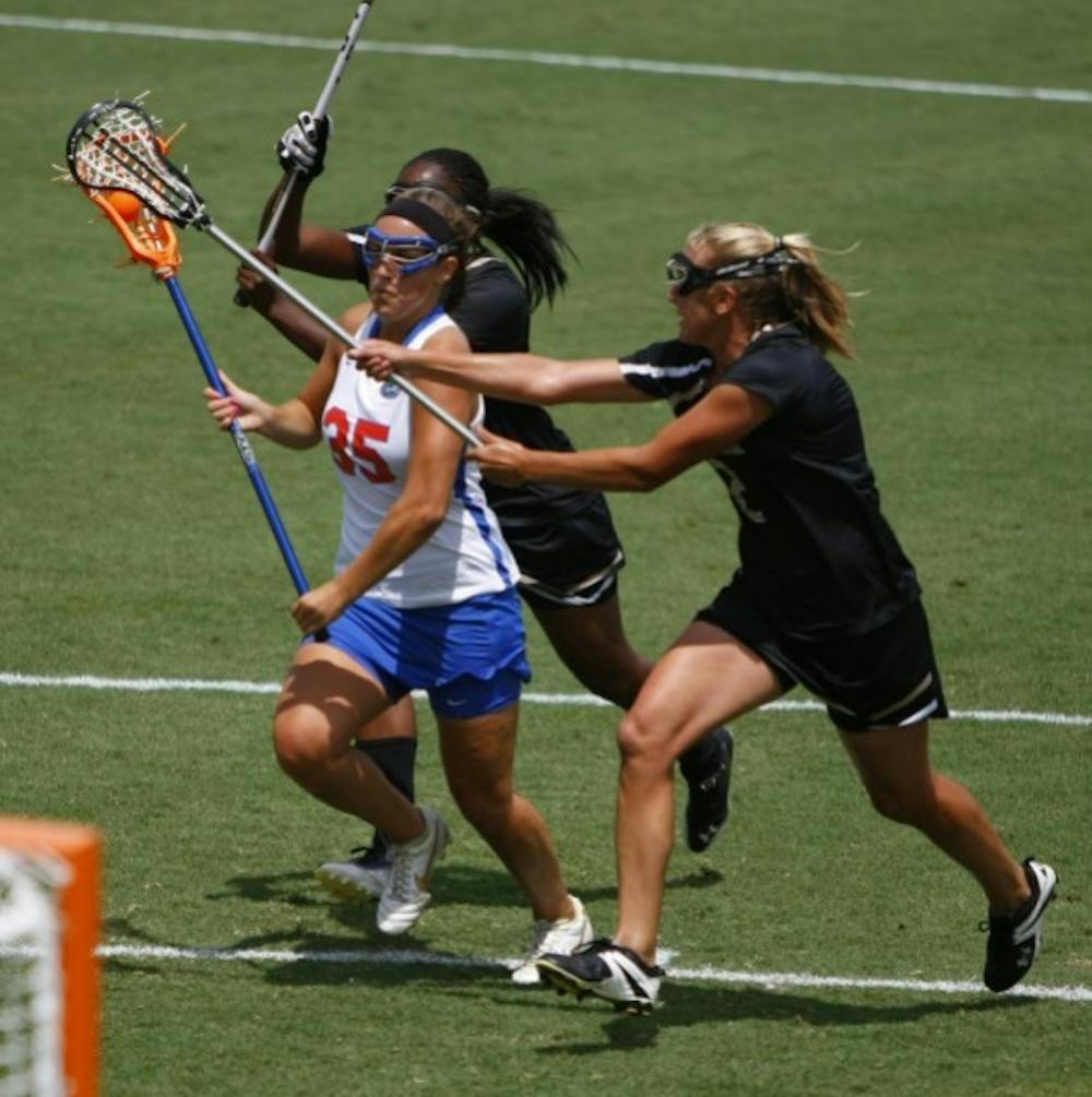 <p align="justify">Florida attacker Gabi Wiegand drives between two defenders in a game against Vanderbilt on April 14. Wiegand scored the game-winning goal in Florida’s 8-7 win over Northwestern on Saturday.</p>