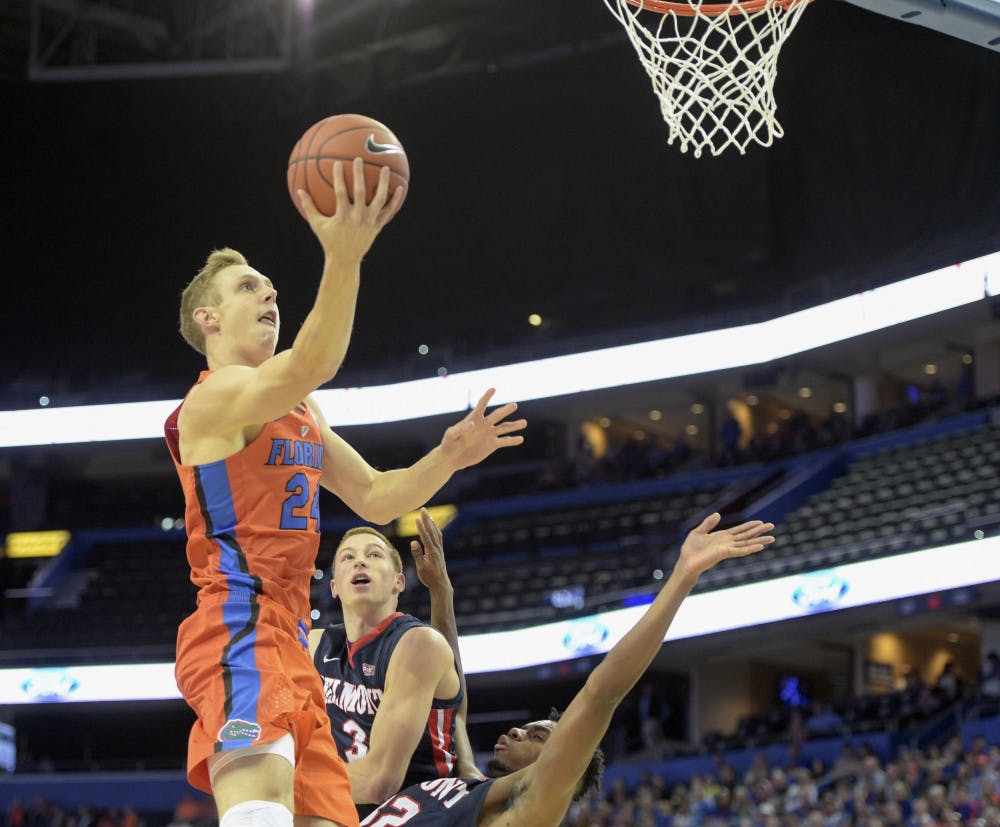 Florida guard Canyon Barry (24) drives to the basket over Belmont forward Amanze Egekeze (32) and guard Dylan Windler (3) in the first half of an NCAA college basketball game in Tampa, Fla., on Monday, Nov/ 21, 2016. (Andres Leiva/Tampa Bay Times via AP)