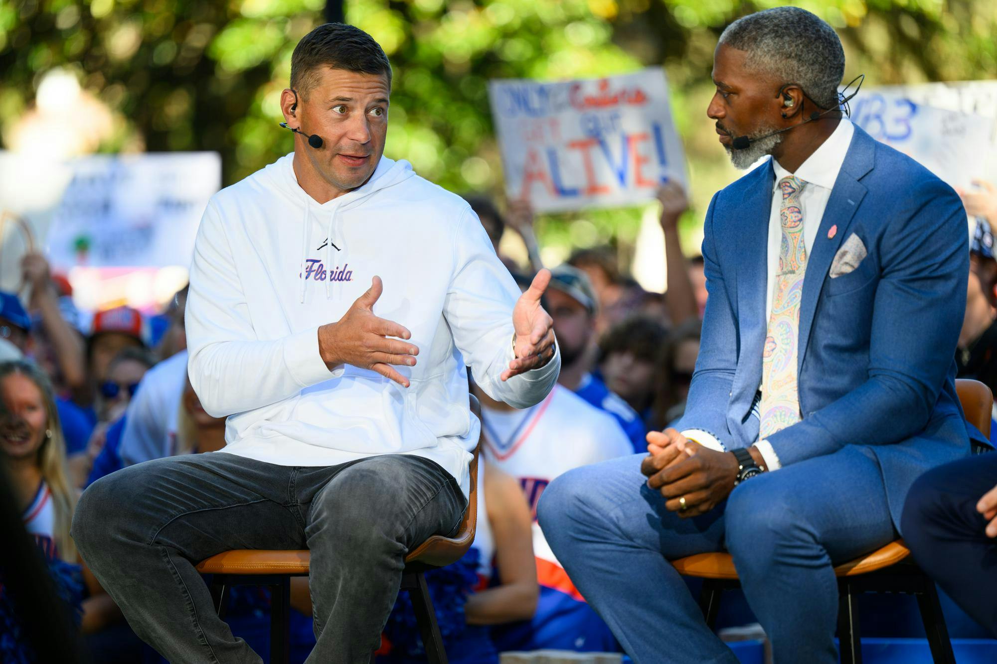 Florida head coach Jon Sumrall (left) talks with ESPN’s Roman Harper during SEC Nation’s show on Plaza of the Americas before Florida hosts Ole Miss, Saturday, Sept. 26, 2026, in Gainesville, Fla.