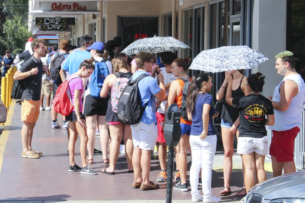 Students line up outside The Coop on University Ave. Wedesnday afternoon for free chicken tenders and sweet tea.