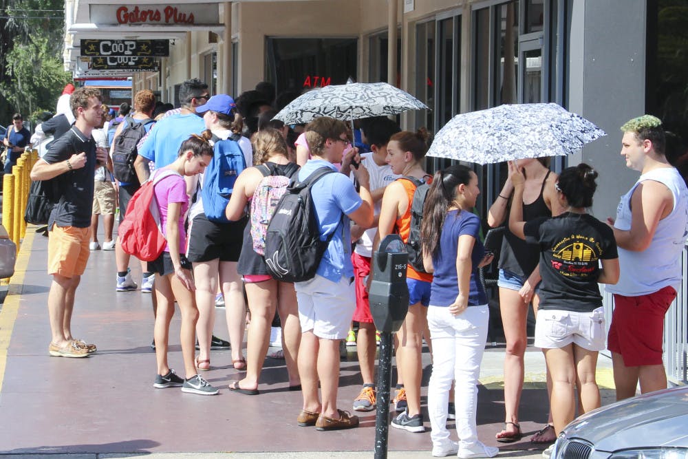 <p>Students line up outside The Coop on University Ave. Wedesnday afternoon for free chicken tenders and sweet tea.</p>