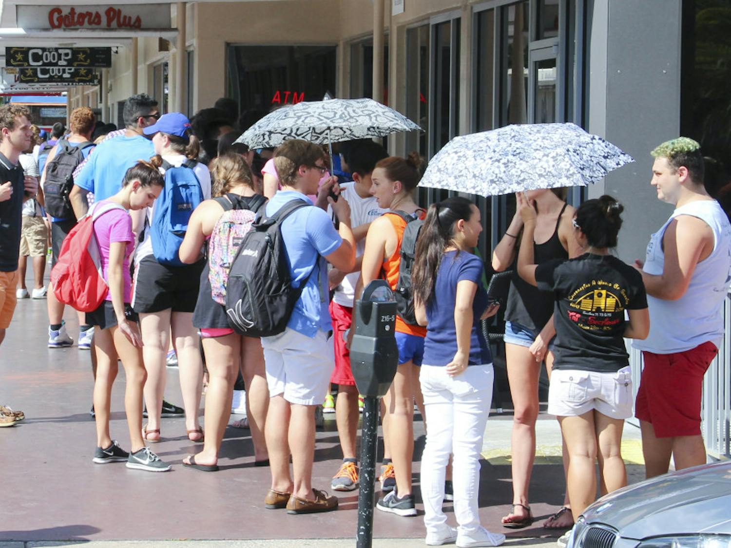 Students line up outside The Coop on University Ave. Wedesnday afternoon for free chicken tenders and sweet tea.