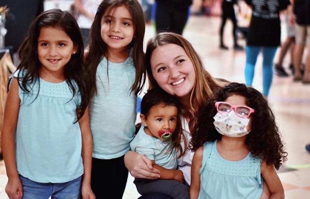 <p><span>Madison Grasty smiles for a group photo with Izabella Neira (far right) and her three sisters (from left) Jessy, Mia and Alynna during a high school Dance Marathon.</span></p>