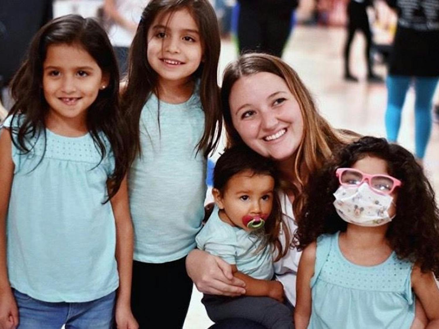 Madison Grasty smiles for a group photo with Izabella Neira (far right) and her three sisters (from left) Jessy, Mia and Alynna during a high school Dance Marathon.