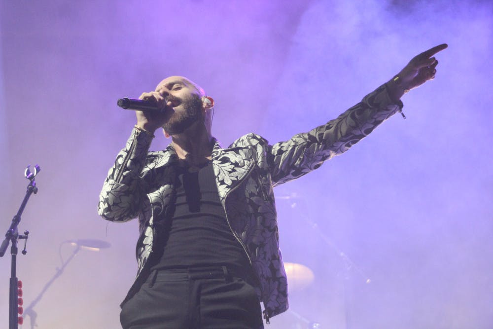 <p>Sam Harris of X Ambassadors sings at Flavet Field on Thursday. Both X Ambassadors and Real Estate played to a crowd of several hundred.</p>