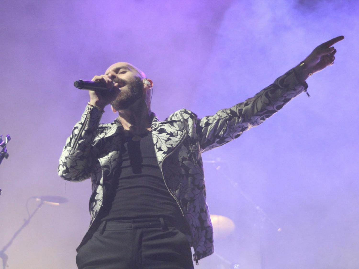 Sam Harris of X Ambassadors sings at Flavet Field on Thursday. Both X Ambassadors and Real Estate played to a crowd of several hundred.