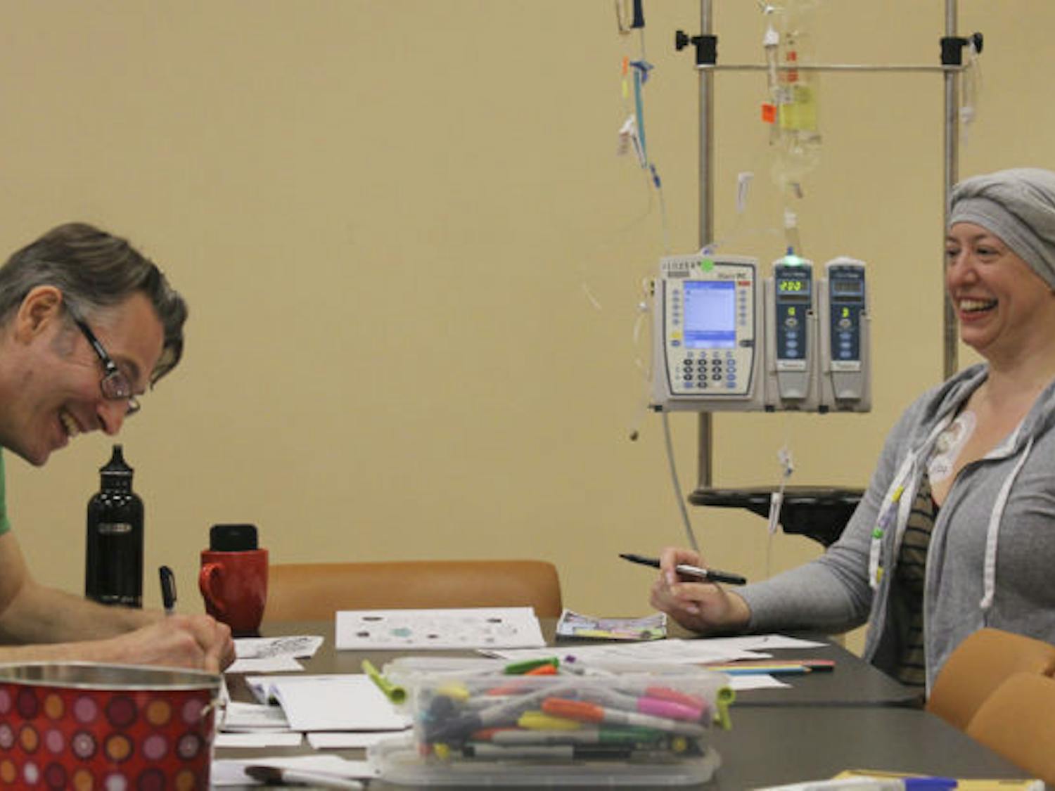 Cancer patient Cindy Craig, 40, and Creative for Health workshop leader Dylan Klempner, 41, spend the rainy evening crafting Zentangles at UF Health Shands Cancer Hospital on Tuesday. Zentangle is an art form known to reduce stress.&nbsp;