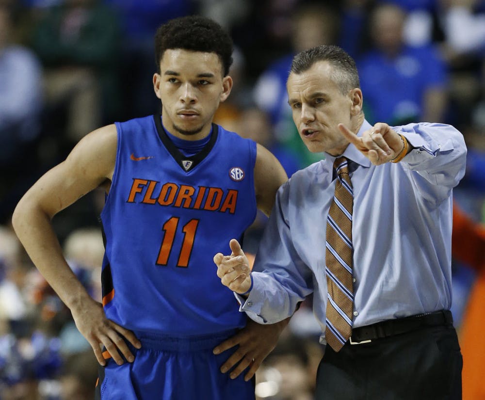 Florida head coach Billy Donovan speaks with Florida guard Chris Chiozza (11) during the second half of an NCAA college basketball game in the quarter final round of the Southeastern Conference tournament against the Kentucky, Friday, March 13, 2015, in Nashville, Tenn.