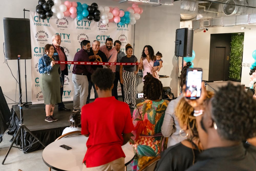 <p>CEO of City Food Hall Paul Rounce cuts the ribbon during the grand opening on Aug. 29, 2024.</p>