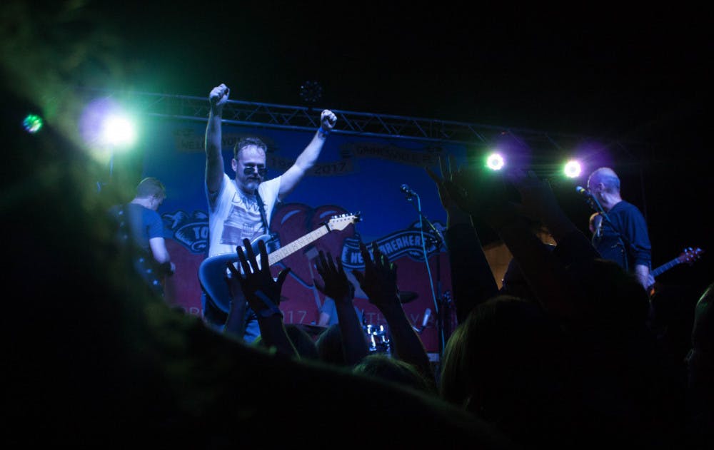 Lead singer Jason Hedges of Heavy Petty, a Tom Petty and the Heartbreakers tribute band, gets the crowd excited during the Tom Petty tribute show held at Heartwood Soundstage, located at 619 S. Main St., on Friday night. That day would have been Tom Petty’s 67th birthday. Hundreds of Gainesville locals came to the free event to celebrate the life of the local musician.