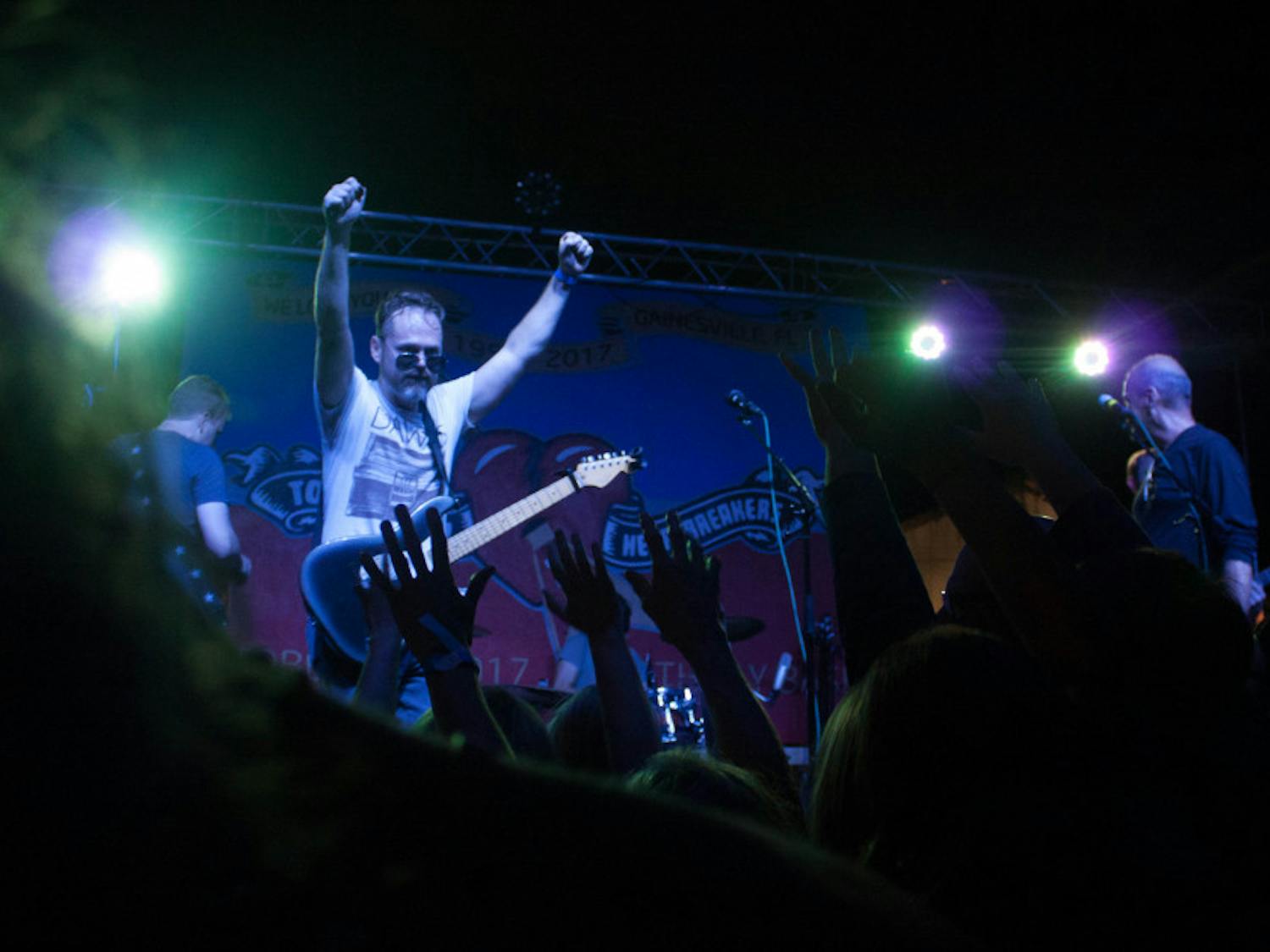 Lead singer Jason Hedges of Heavy Petty, a Tom Petty and the Heartbreakers tribute band, gets the crowd excited during the Tom Petty tribute show held at Heartwood Soundstage, located at 619 S. Main St., on Friday night. That day would have been Tom Petty’s 67th birthday. Hundreds of Gainesville locals came to the free event to celebrate the life of the local musician.