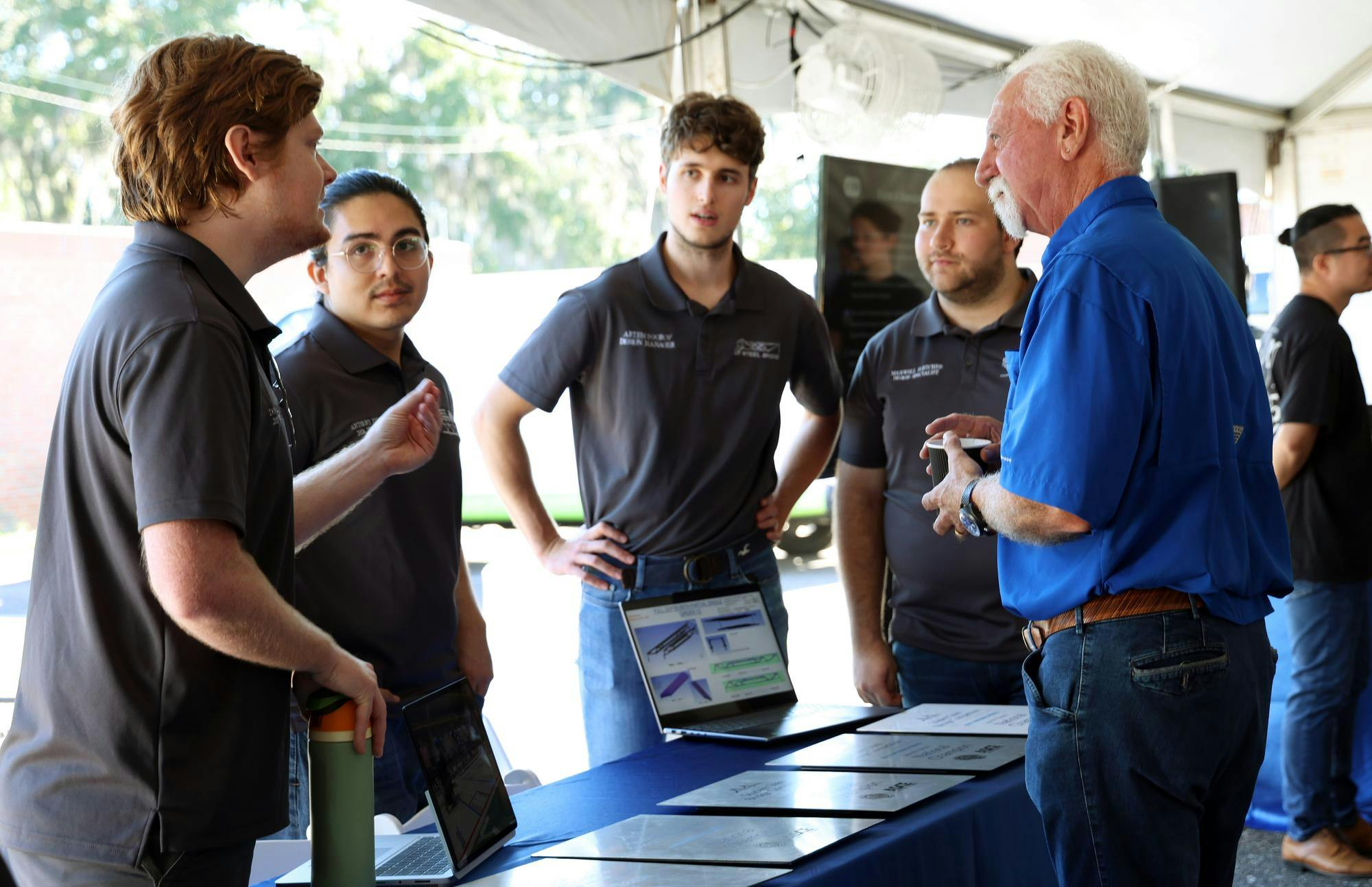Chris Malachowsky, co-founder of computer graphics company Nvidia, speaks with students about their engineering projects during the unveiling ceremony of the fourth generation of HiPerGator, the most powerful university-owned supercomputer in the U.S., at UF East Campus on Tuesday, Oct. 14, 2025.