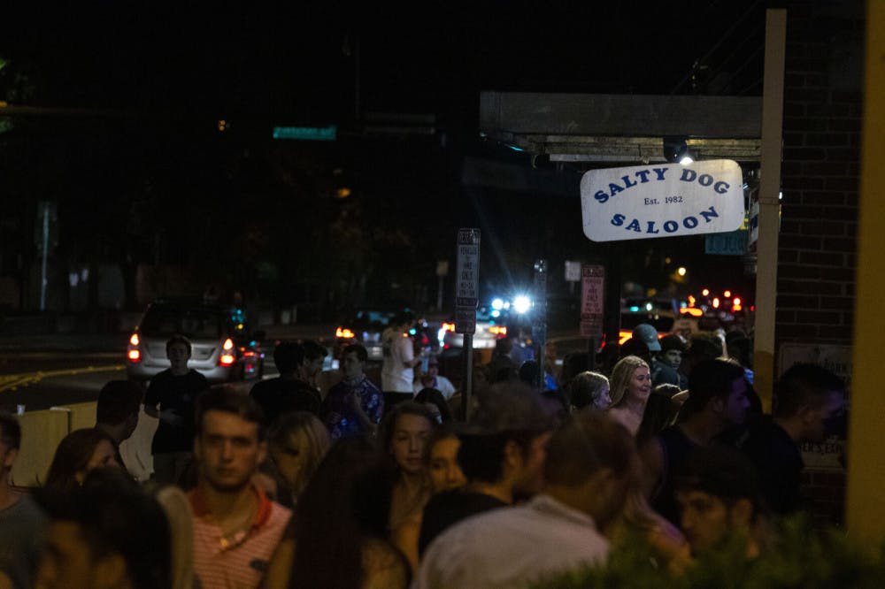 More than 50 people are seen waiting outside next to Salty Dog Saloon and Fat Daddy’s, located at Midtown off of West University Avenue in Gainesville.