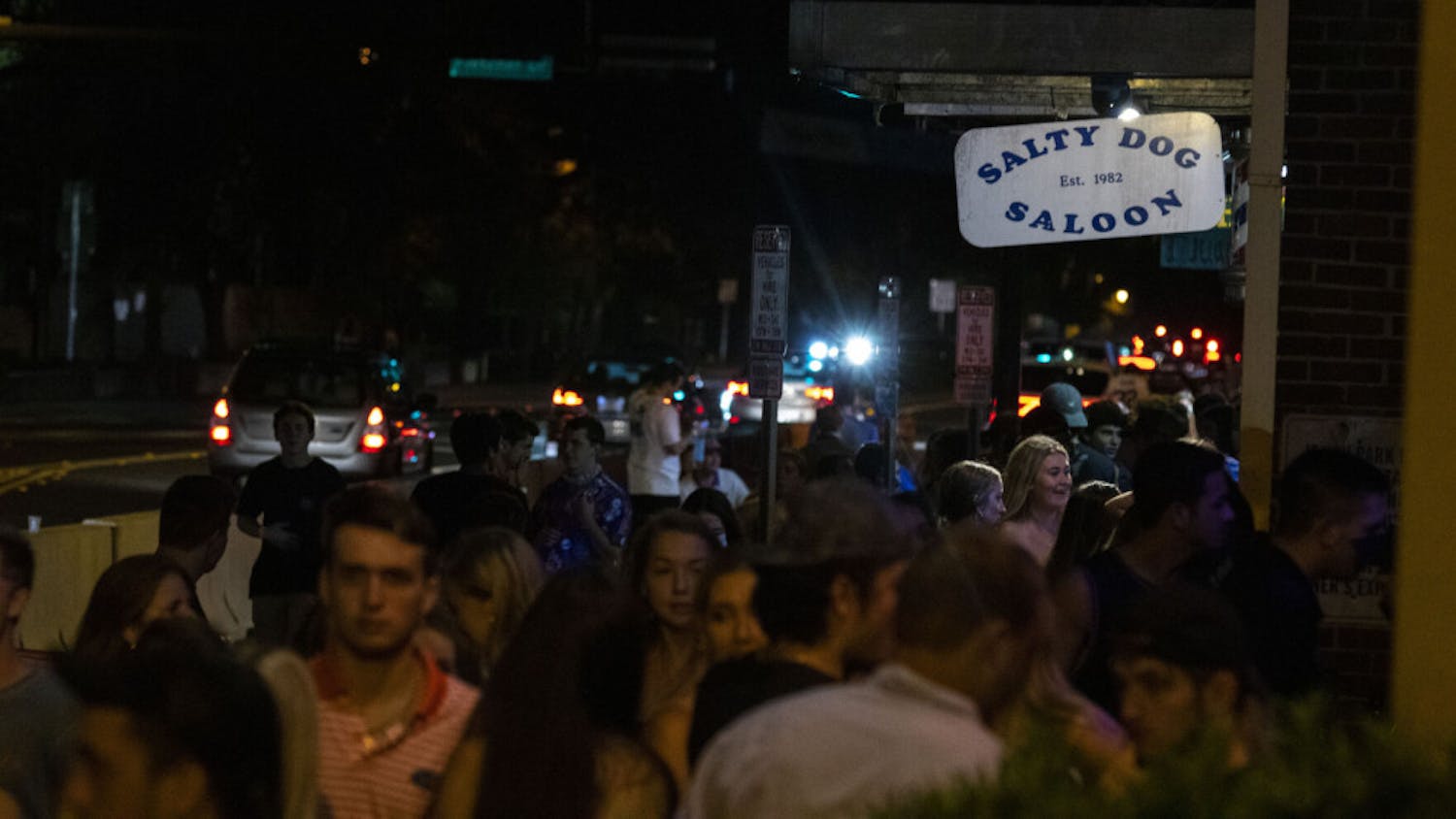 More than 50 people are seen waiting outside next to Salty Dog Saloon and Fat Daddy’s, located at Midtown off of West University Avenue, in Gainesville on Saturday night, after the first home football game. (Zachariah Chou/Alligator Staff)