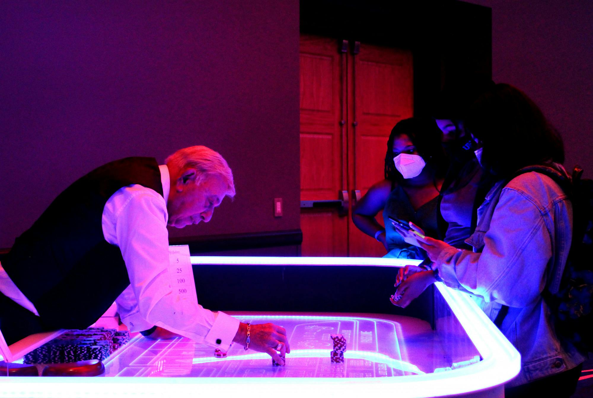 Students play a game of poker at the Reitz Union Grand Ballroom on Friday, Jan. 28. The event was the inaugural Gator Gala, a get-together for students with games, food and a dance floor.