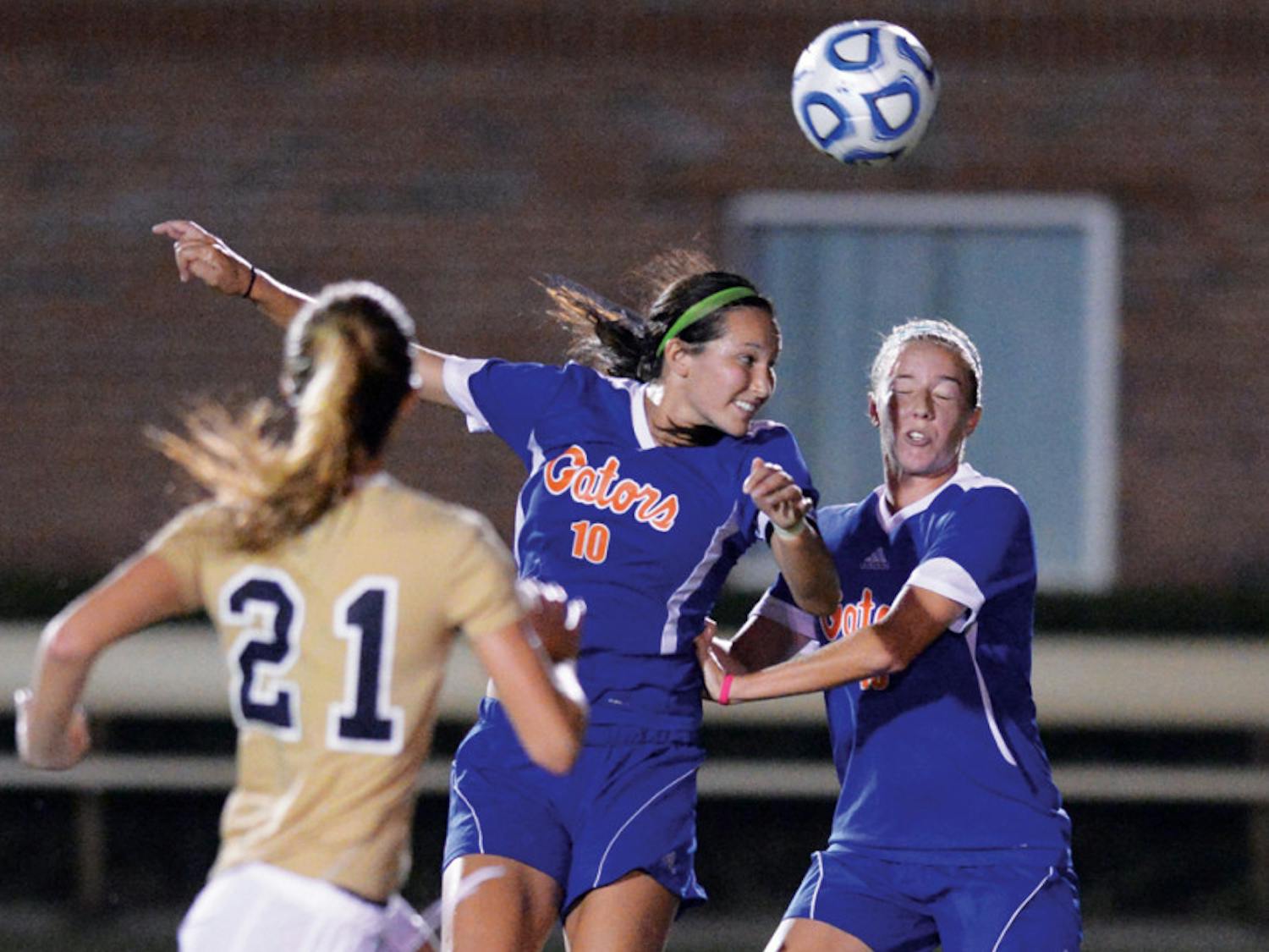 Midfielder Holly King (10) heads a ball during UF's 3-0 victory against Florida International University on Sept. 2. King works as an elementary school teacher at Levy County elementary school every Wednesday.
