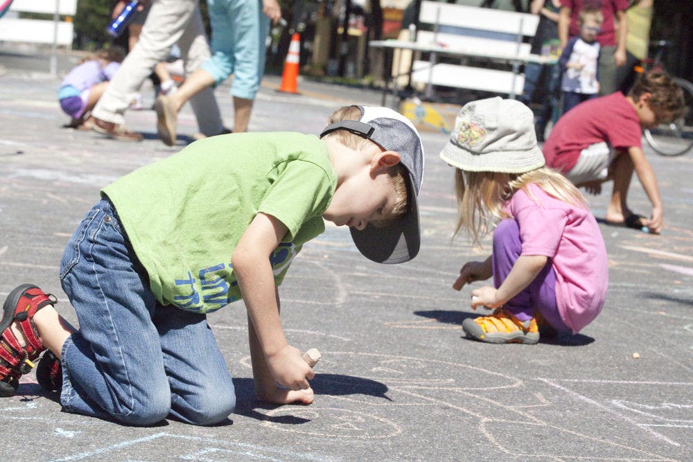Andrew Bittikoffer, 5, and Ella Bittikoffer, 3, draw with chalk during Gainesville’s Open Streets event. Their mother, Katherine Bittikoffer, said, “I’ve always seen big cities have events like these. It’s about time Gainesville stepped up.”