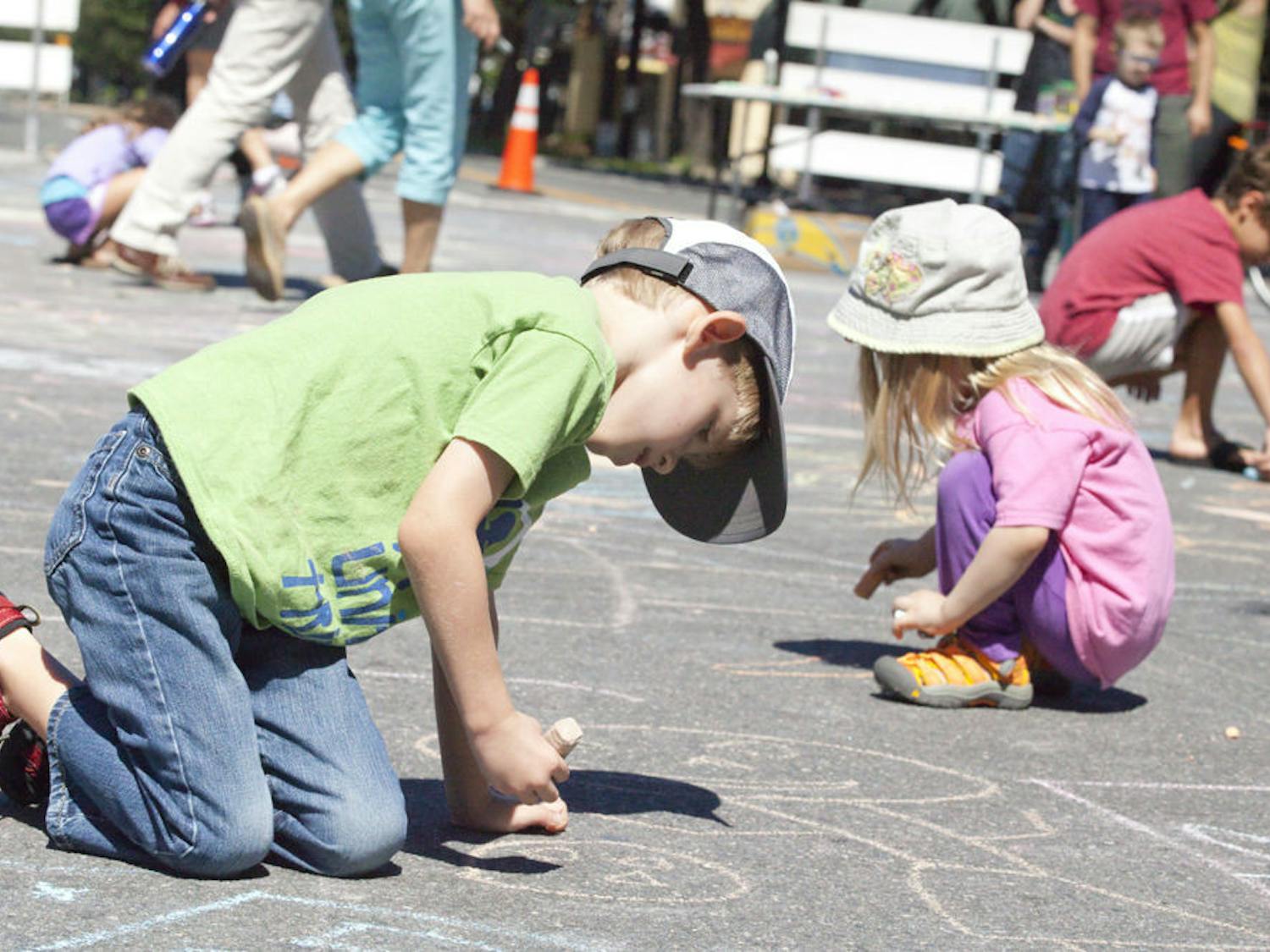 Andrew Bittikoffer, 5, and Ella Bittikoffer, 3, draw with chalk during Gainesville’s Open Streets event. Their mother, Katherine Bittikoffer, said, “I’ve always seen big cities have events like these. It’s about time Gainesville stepped up.”