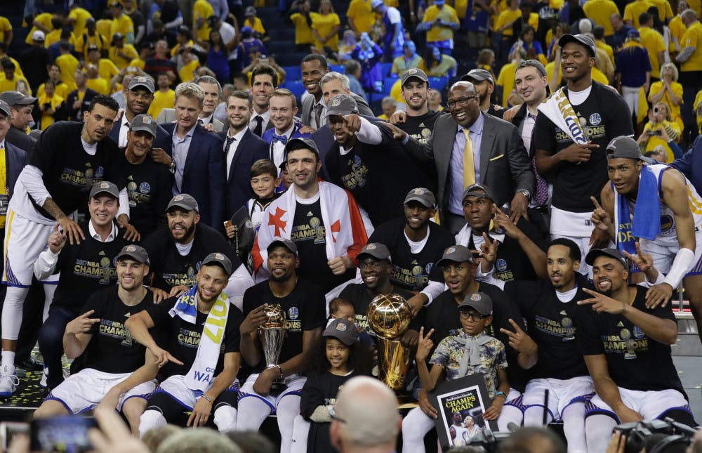 The Golden State Warriors celebrate winning the NBA Finals on Monday following their 129-120 win over the Cleveland Cavaliers.