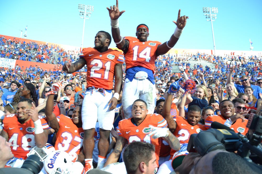 <p>UF running back Kelvin Taylor (21) and defensive end Alex McCalister (14) celebrate with teammates after clinching the SEC East with its 9-7 win against Vanderbilt on Nov. 7, 2015, at Ben Hill Griffin Stadium.</p>