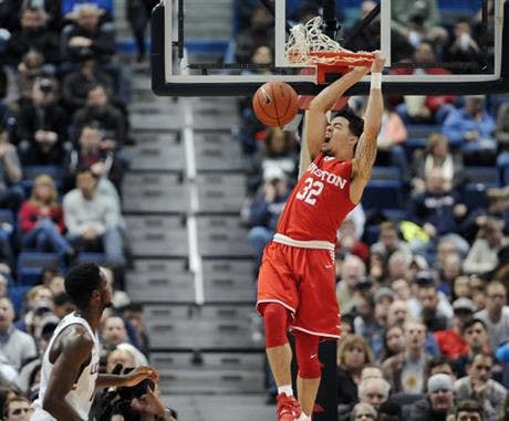 Houston's Rob Gray reacts while dunking the ball as Connecticut's Kentan Facey, left, looks on, in the first half of an NCAA college basketball game, Wednesday, Dec. 28, 2016, in Hartford, Conn. (AP Photo/Jessica Hill)