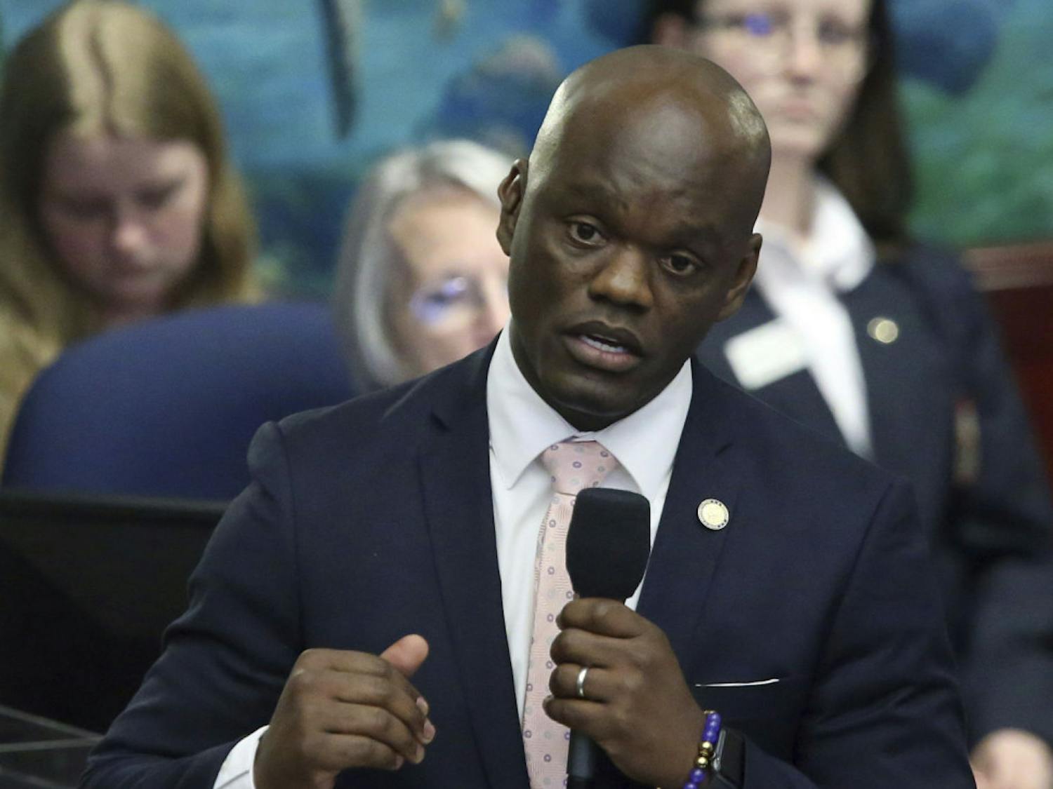 FILE - In this Wednesday April 24, 2019 file photo, Rep. Kionne McGhee, D-Miami, debates the felon voting rights bill during session in Tallahassee, Fla. Following California's lead, Florida lawmakers are tackling NCAA rules that prohibit college athletes from reaping financial benefits from their prowess in the arena of big-money sports. A proposal by state House Democratic Leader Kionne McGhee is modeled after one signed into law last month by California Gov. Gavin Newsom that allows college athletes in the Golden State to sign endorsement deals and hire agents without endangering scholarships and their eligibility to participate in NCAA-sanctioned sports. (AP Photo/Steve Cannon, File)
