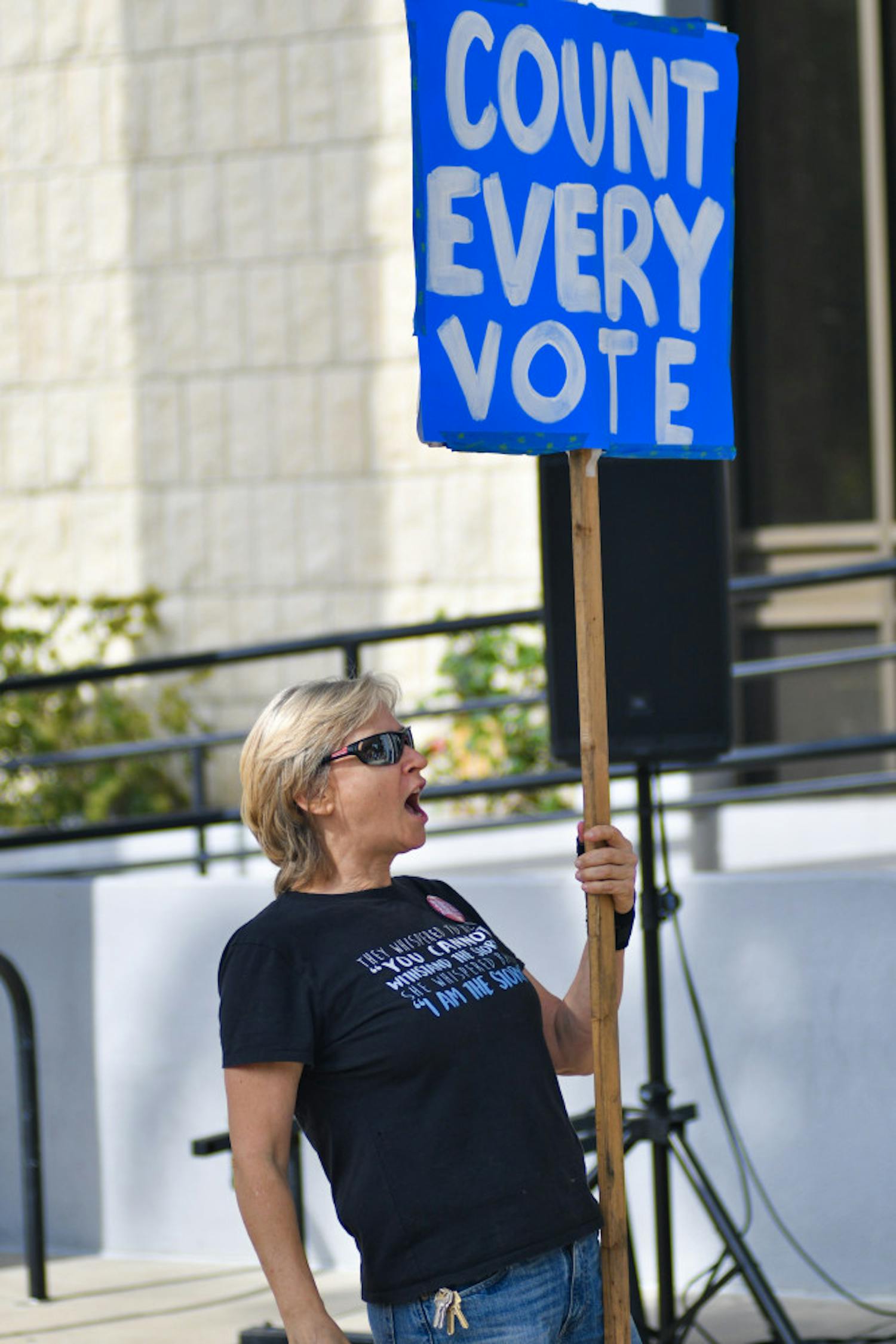Janet Suggs, a 59-year-old Gainesville residents chants “Count Every Vote” outside city hall Sunday afternoon. About 50 people attended the Count Every Vote rally which was hosted by Our Revolution North Central Florida in order to support the Supervisors of elections as well as gain volunteers to assist with the recount.