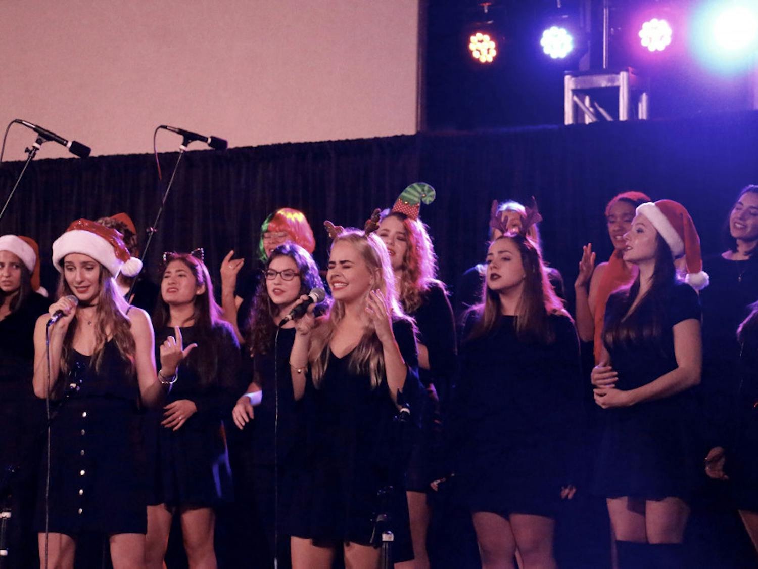 Olivia Serrano, an 18-year-old UF business administration and psychology freshman, leads the a cappella group The Sedoctaves in their performance at the 28th Annual Pond Lighting at North Florida Regional Medical Center.