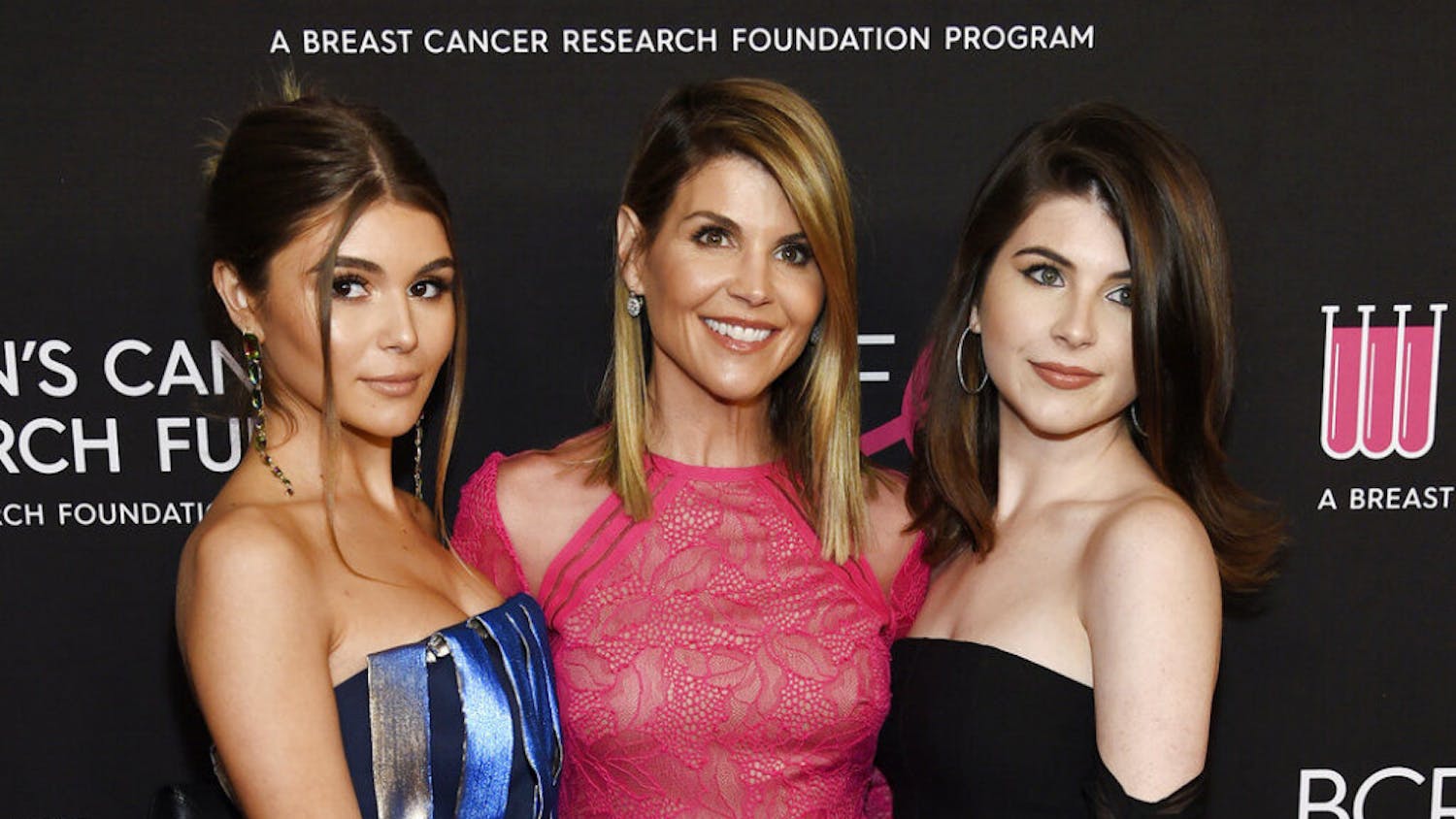 FILE - In this Feb. 28, 2019 file photo, actress Lori Loughlin, center, poses with daughters Olivia Jade Giannulli, left, and Isabella Rose Giannulli at the 2019 "An Unforgettable Evening" in Beverly Hills, Calif. Loughlin and her husband Mossimo Giannulli were charged along with nearly 50 other people Tuesday in a scheme in which wealthy parents bribed college coaches and other insiders to get their children into some of the most elite schools in the country, federal prosecutors said. (Photo by Chris Pizzello/Invision/AP, File)