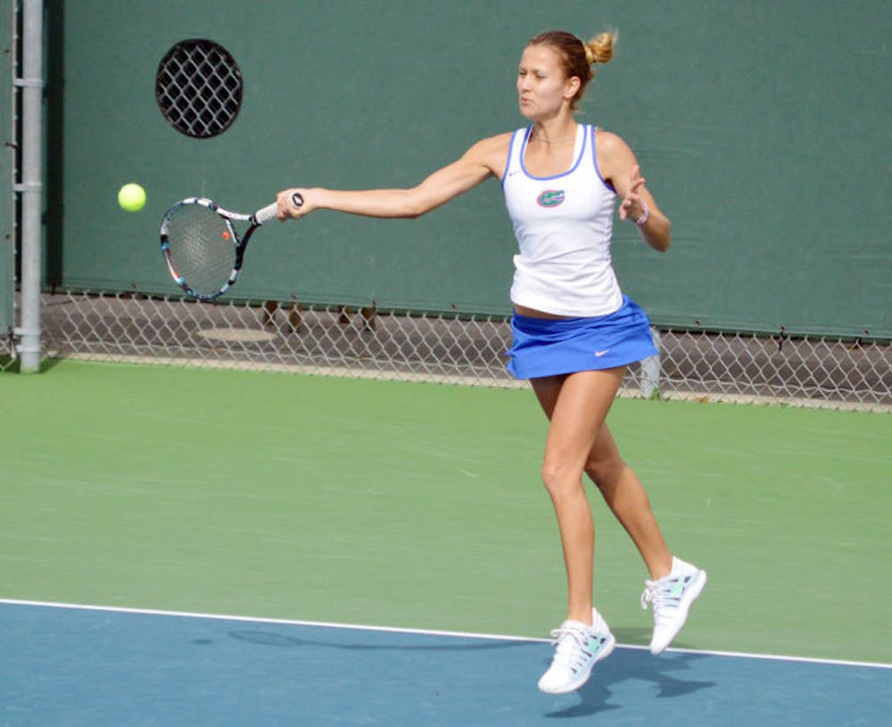 <p>Olivia Janowicz returns the ball during Florida’s 4-0 win against Harvard on Jan. 26 at the Ring Tennis Complex.</p>