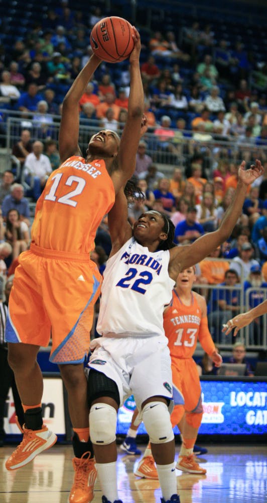 Bashaara Graves (12) grabs a rebound over Kayla Lewis (22) in Sunday’s game.