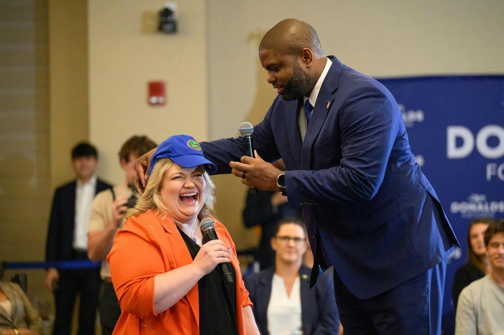 Representative and gubernatorial candidate Byron Donalds puts a Gators hat on representative Kat Cammack’s head during a town hall as a part of his Defending the Florida Dream Tour, Wednesday, Sept. 30, 2026, in Gainesville, Fla.