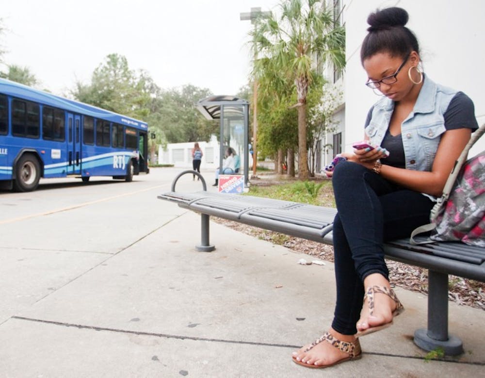 <p>Whitney Jeter, a 19-year-old health sciences sophomore, waits to take the No. 23 bus home after her Marriage and Family class at Sante Fe College on Tuesday afternoon.</p>