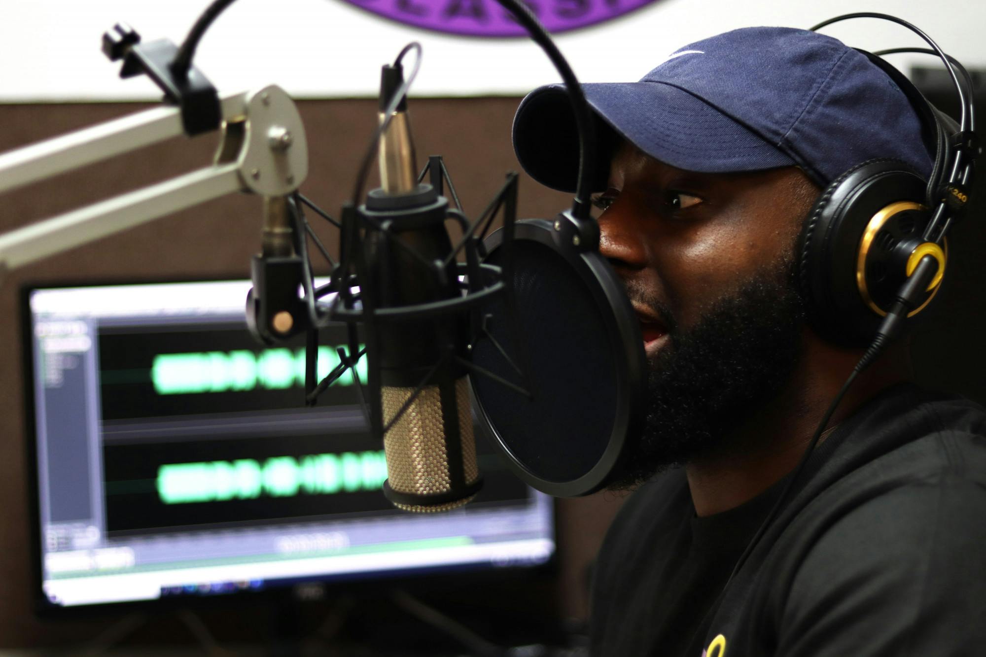 Ardell Wright speaks to a caller as he records the conversation on the computer in the 98.9 Jamz Studio on Monday, Nov. 16, 2020. Wright edited the audio and then played it on the air. (Lauren Witte/Alligator Staff)
