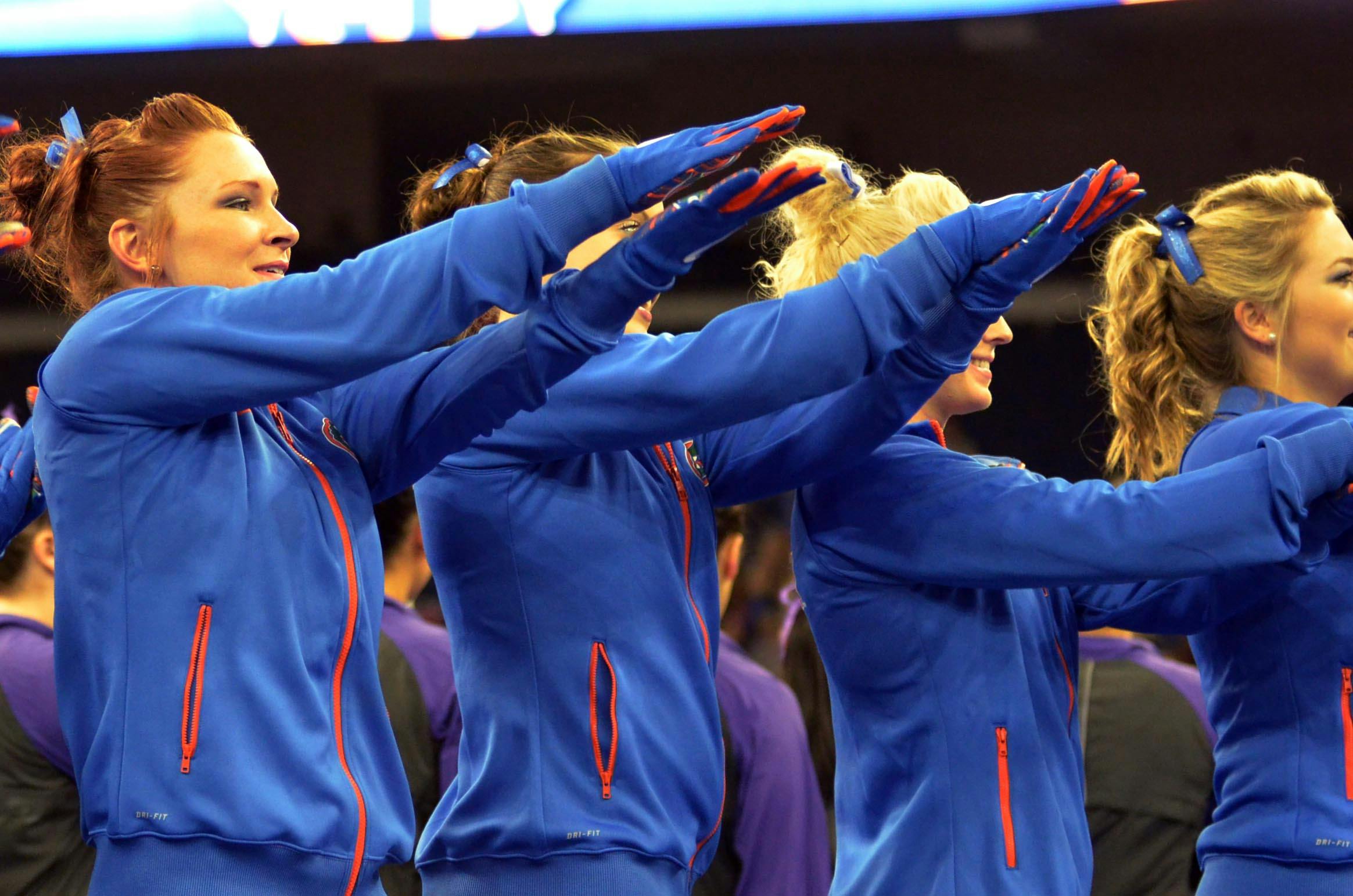 Bridget Sloan (left) and teammates Gator chomp prior to the Southeastern Conference Championships on March 21 in Duluth, Georgia.