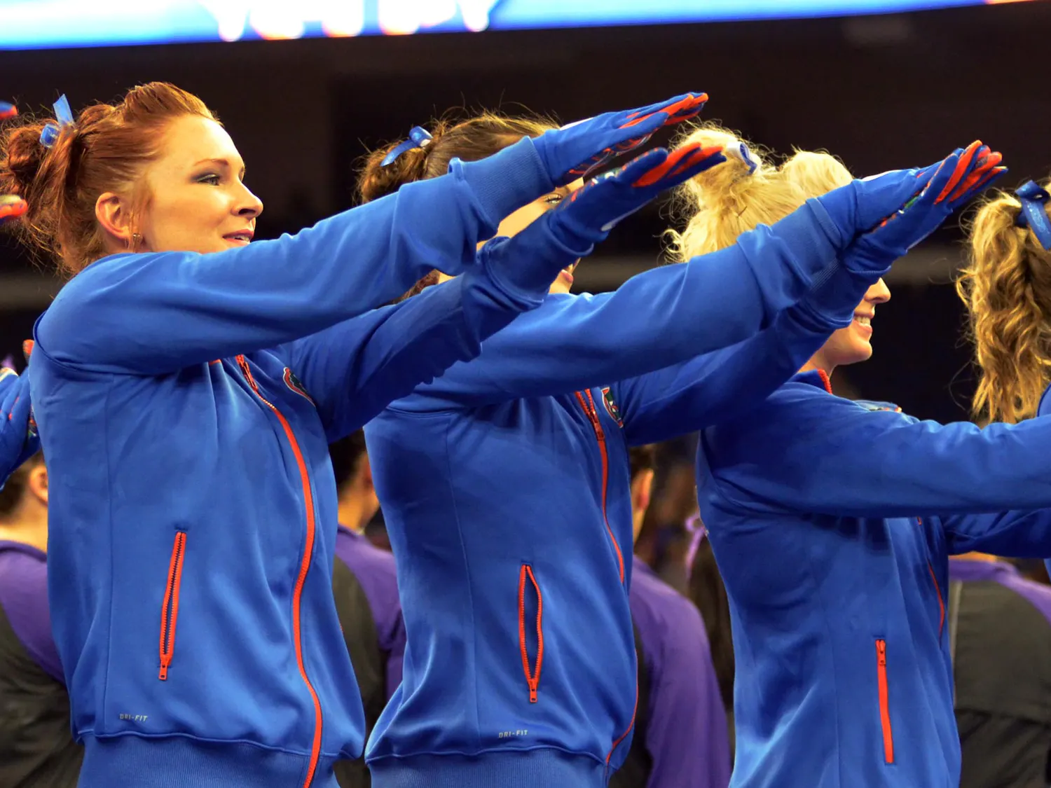 Bridget Sloan (left) and teammates Gator chomp prior to the Southeastern Conference Championships on March 21 in Duluth, Georgia.
