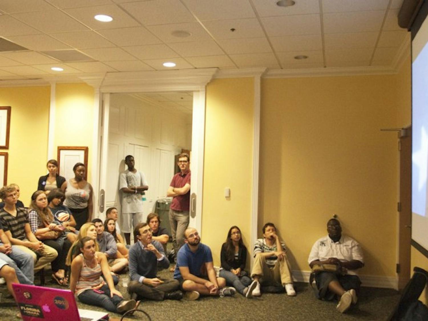 Students watch President Barack Obama’s 2012 presidential nomination acceptance speech on a projector screen in the Matthews Suite on the fourth floor of the Reitz Union on Thursday night.