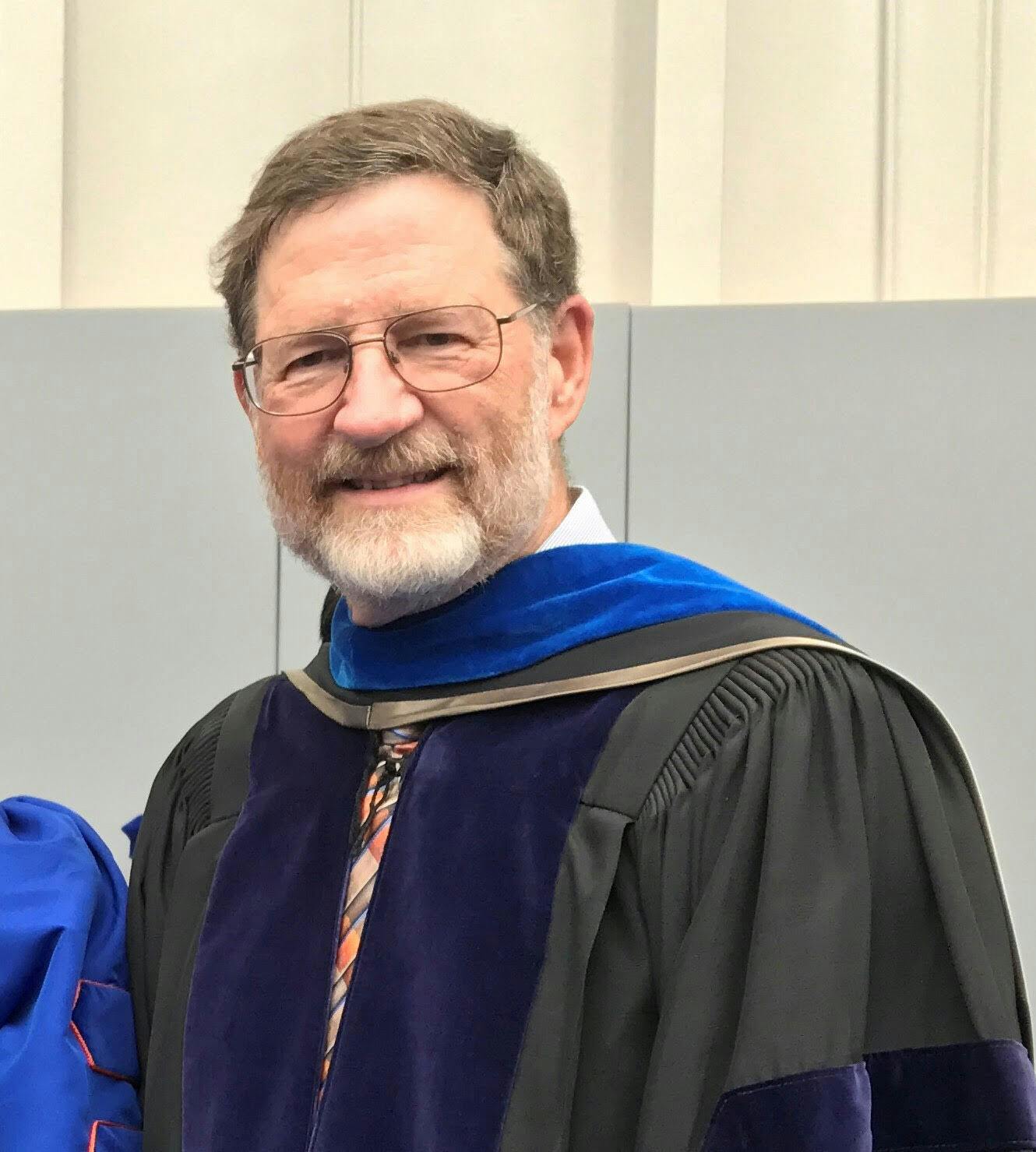 Richard Yost, 66, pictured in April 2019 at a PhD commencement ceremony where he escorted his most recent PhD graduate student.