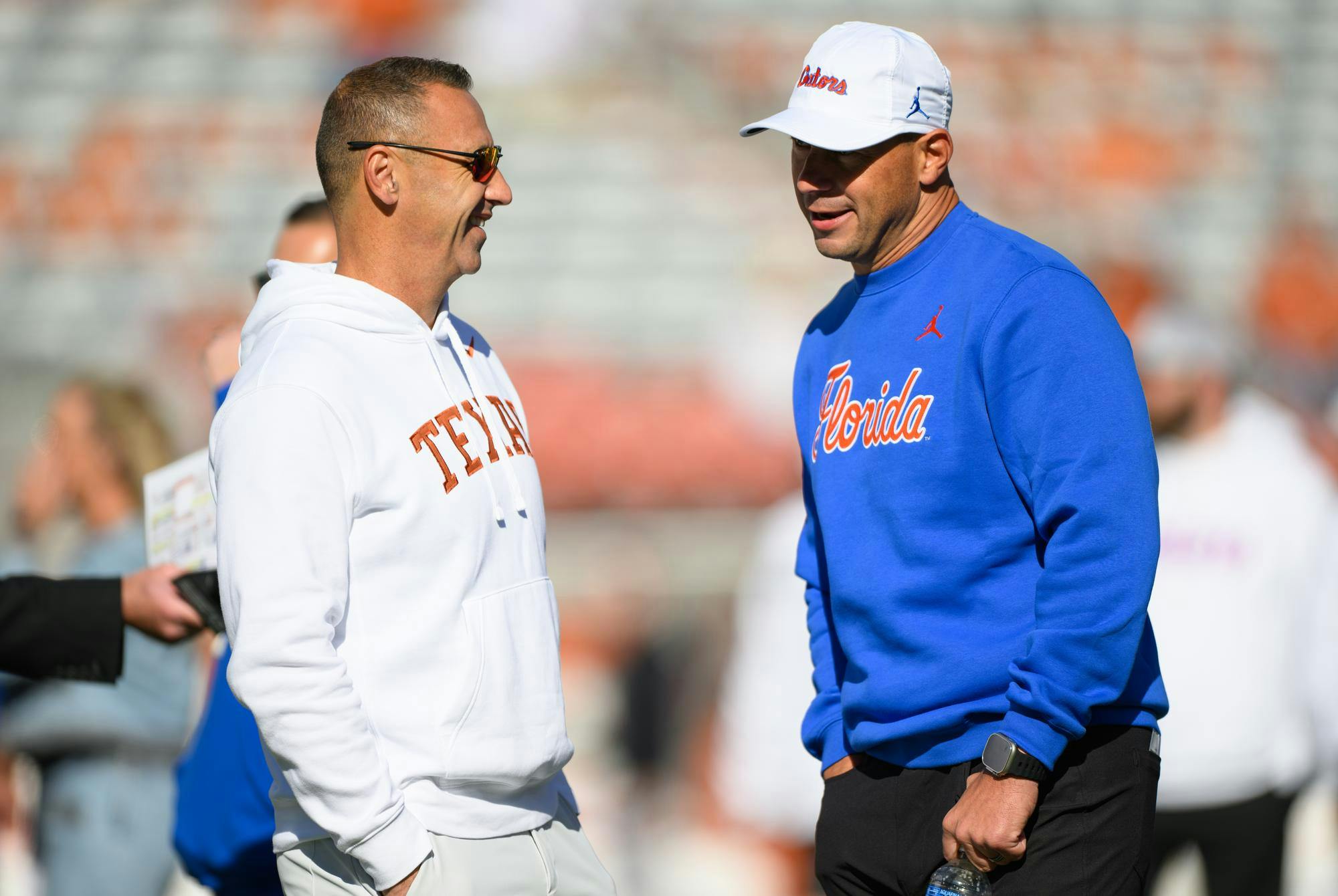 Florida head coach Jon Sumrall talks with Texas head coach Steve Sarkisian before an NCAA college football game, Friday, Oct. 16, 2026, in Austin, Texas.