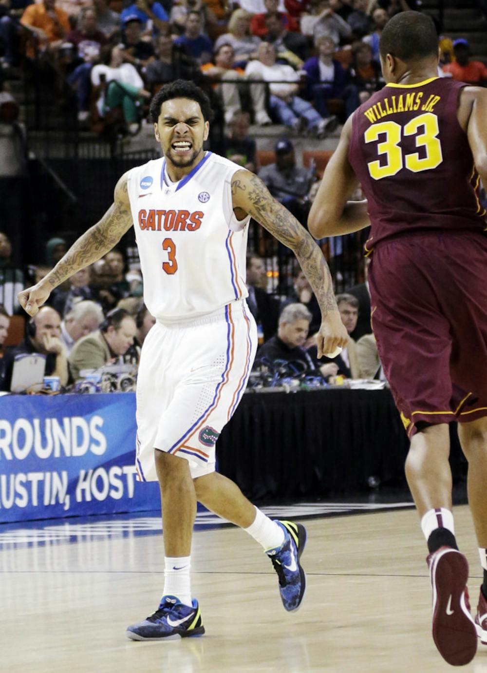 <p class="p1"><span class="s1">Redshirt senior guard Mike Rosario (3) reacts after hitting a three-pointer as Minnesota’s Rodney Williams Jr. (33) runs down the court during the Gators’ 78-64 win against the Golden Gophers on Sunday in Austin, Texas. Rosario led UF with 25 points in the victory. </span></p>